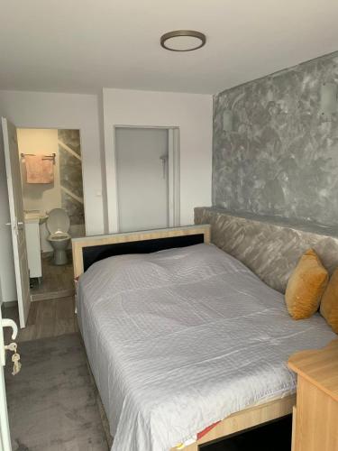 a bedroom with a bed with a large headboard at Casa Alexandreea in Orşova