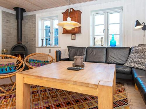 a living room with a couch and a table at 8 person holiday home in Ringkøbing-By Traum in Ringkøbing