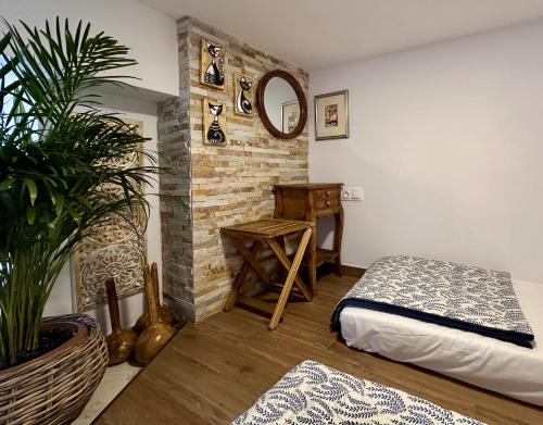 a bedroom with a bed and a mirror and a plant at Avra Guesthouse in Limenas