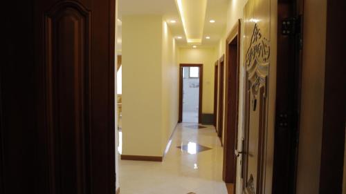 an empty hallway with a hallway leading to a room at My dream apartment in Addis Ababa