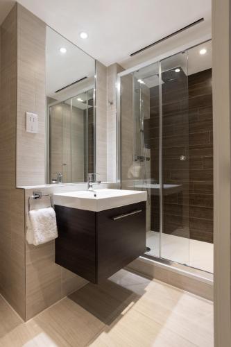 a bathroom with a sink and a shower at Native Tower Bridge in London
