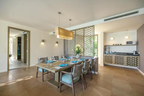 a dining room with a table and chairs at Mia Resort Nha Trang in Nha Trang