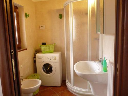 a bathroom with a washing machine and a sink at Il Basciutin in Pettenasco