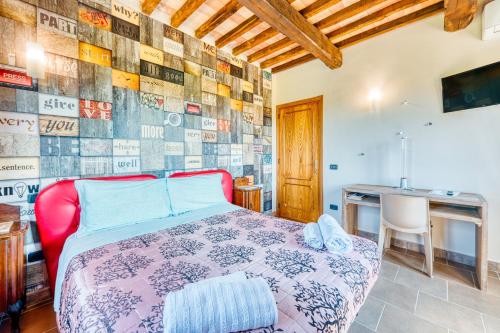 a bedroom with a bed and a table and a desk at Casale Rialto in Montefalco