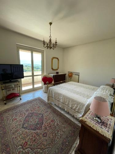 a bedroom with a bed and a television and a window at Casa relax e vacanza Il Moraiolo in Stroncone