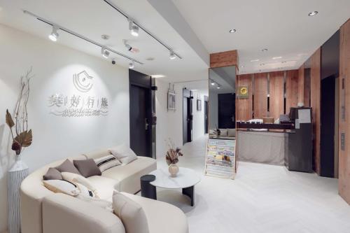 a living room with a couch and a table at Wondertime Taipei Station - Chongqing Inn in Taipei