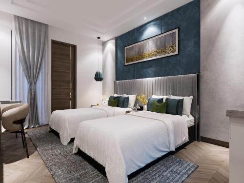 two beds in a hotel room with a wall at Solace Suites Hotel & Banquets in Barog