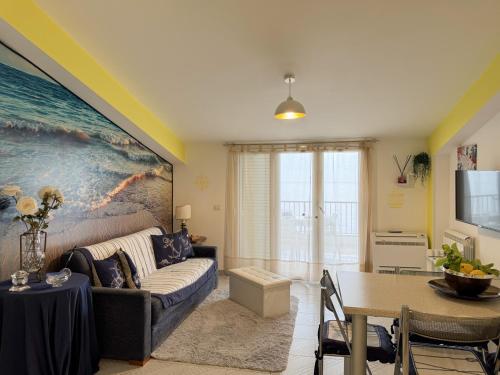 a living room with a couch and a table at La Mansarda in Marina di Gioiosa Ionica