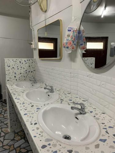 a bathroom with two sinks and a mirror at 99 hostel in Ko Tao
