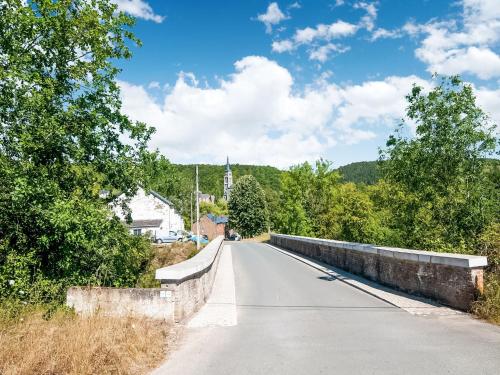 a bridge over a road in a small town at Holiday Home in Treignes for 9 Person in Treignes