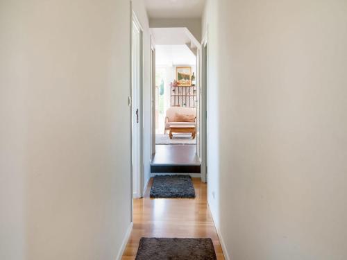 a hallway with a door leading to a living room at Holiday Home in Treignes for 9 Person in Treignes