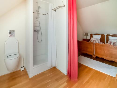 a bathroom with a toilet and a bed in a room at Holiday Home in Treignes for 9 Person in Treignes