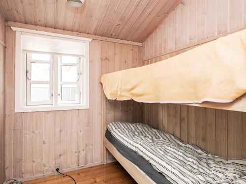a bedroom with a bed and a window at 6 person holiday home in Jerup in Jerup