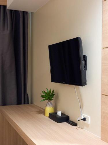 a flat screen tv hanging on a wall at Apasari Krabi - SHA Extra Plus in Ao Nang Beach