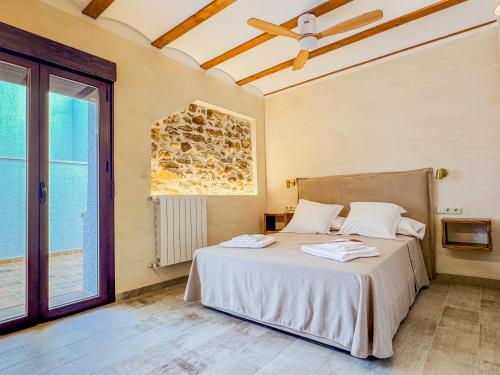 a bedroom with a bed and a large window at Complejo El Molinico in Puebla de Don Fadrique