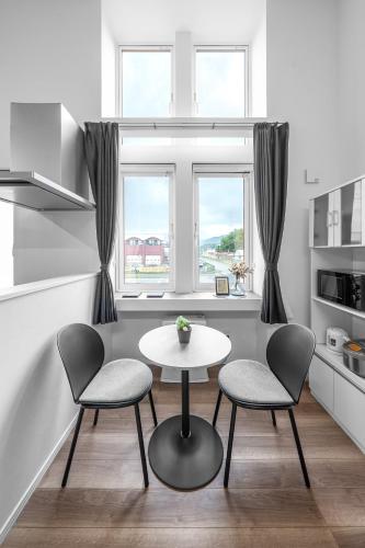 a kitchen with two chairs and a table and a window at Furano Resort Wakaba D in Furano