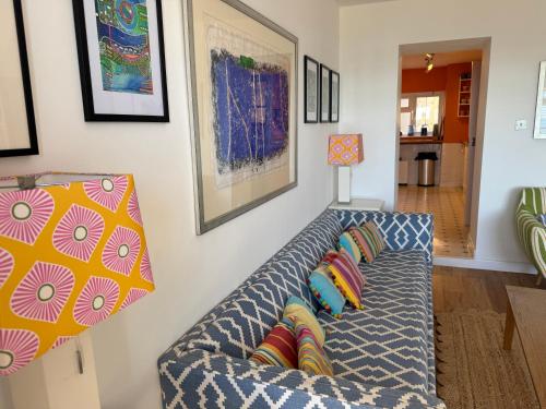 a living room with a couch with pillows at Sea views at Quay Rocks in Seaview