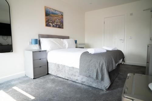 a bedroom with a large bed and a television at Taigh Mor in Elgin