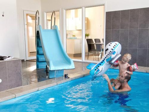two young men playing in a swimming pool at Luxury Retreat by the Sea - By Traum Ferienwohnungen in Høruphav