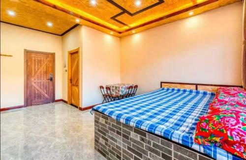 a bedroom with a bed and a wooden ceiling at Snow house in Sanrenban
