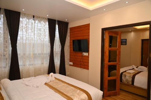 Katil atau katil-katil dalam bilik di Hotel Golden Potala