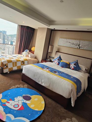a hotel room with two beds and a large window at Guangdong Hotel (Zhuhai) in Zhuhai