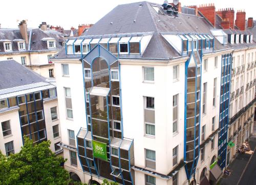 a tall white building with windows on the side of it at ibis Styles Nantes Centre Place Royale in Nantes