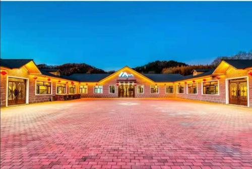 a large building with a driveway in front of it at Snow house in Sanrenban