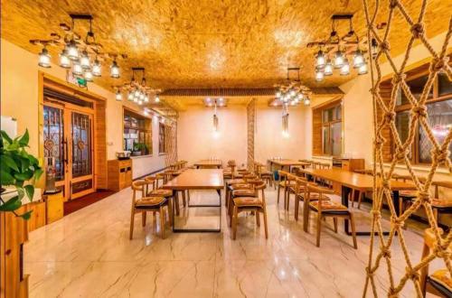 a large dining room with wooden tables and chairs at Snow house in Sanrenban