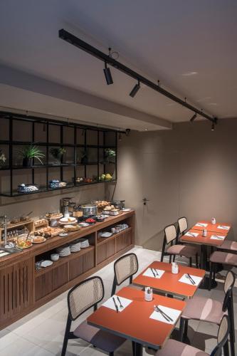 a restaurant with tables and chairs and a buffet at Palazzo Buenos Aires in Milan