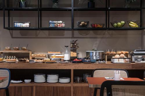 a buffet with plates and food on a table at Palazzo Buenos Aires in Milan