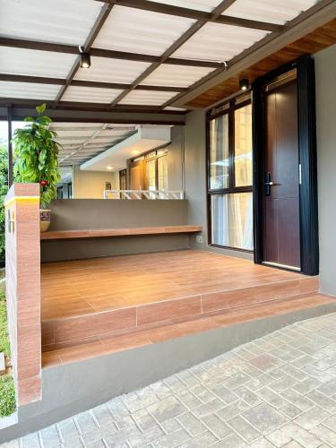 a large empty room with a wooden dance floor at Manna Tatami House KBP Bandung near Wahoo, Whoosh & Parahyangan Golf in Bandung