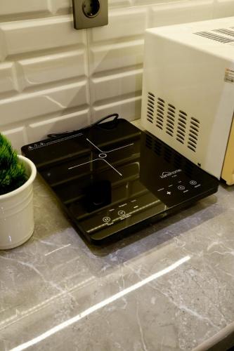 a microwave oven sitting on top of a counter at Manna Tatami House KBP Bandung near Wahoo, Whoosh & Parahyangan Golf in Bandung