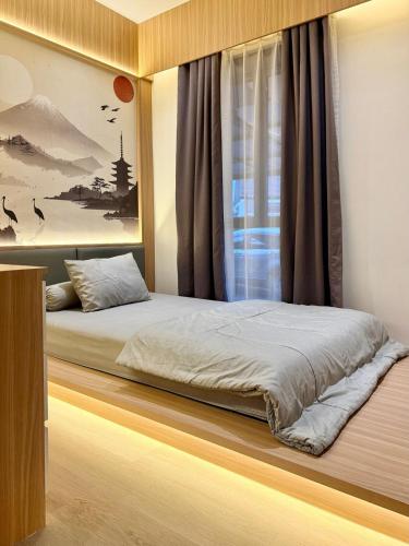 a bedroom with a bed and a window at Manna Tatami House KBP Bandung near Wahoo, Whoosh & Parahyangan Golf in Bandung