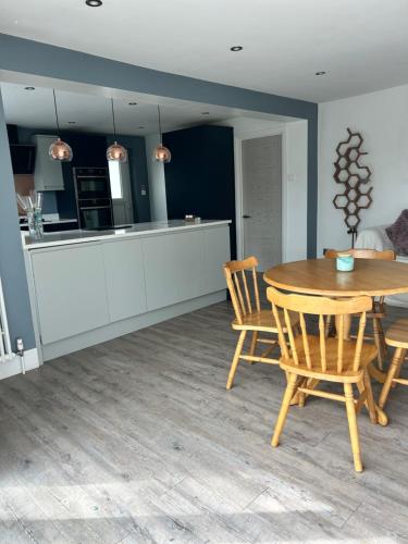 a kitchen and dining room with a table and chairs at St Johns View in Boston Spa