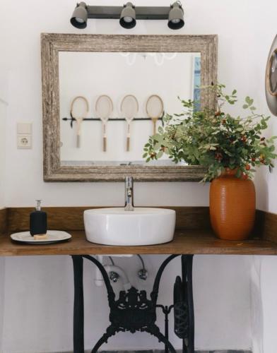 a bathroom with a sink and a mirror at Ceruzás ház in Nagyrákos