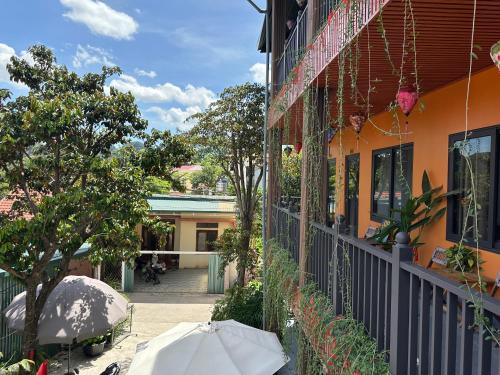 an orange building with an umbrella outside of it at Tam Coc Nam Huyen Homestay in Vũ Lâm