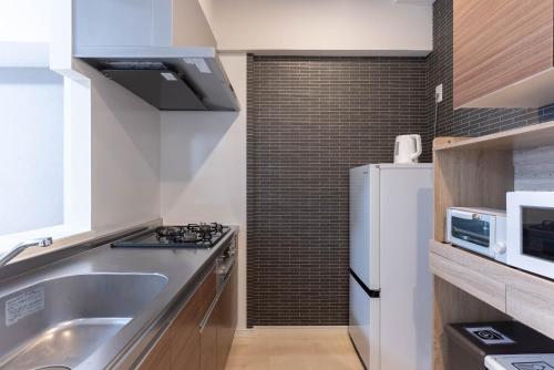 Η κουζίνα ή μικρή κουζίνα στο Ekimae apartment