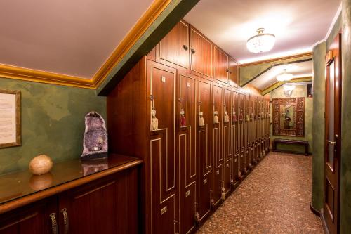 a hallway with wooden lockers in a building at Golden Royal Boutique Hotel & Spa in Košice