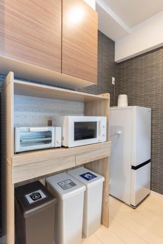 Η κουζίνα ή μικρή κουζίνα στο Ekimae apartment