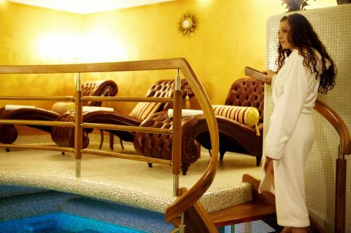 a woman is standing next to a bunk bed at Golden Royal Boutique Hotel & Spa in Košice