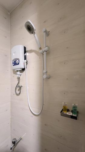 a shower in a bathroom with a shower head at Golden Castle Hotel Hoima in Hoima