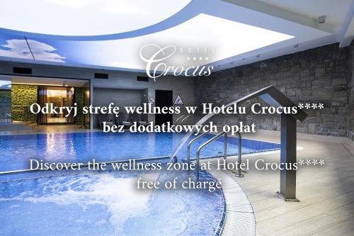 a luxury hotel lobby with a swimming pool at Dom Crocus in Zakopane