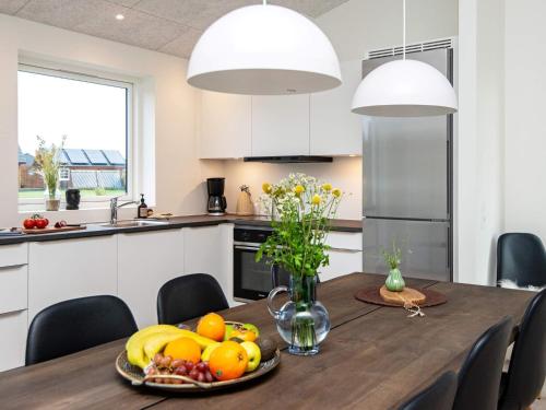 a kitchen with a wooden table with fruit on it at 8 person holiday home in Ansager in Ansager