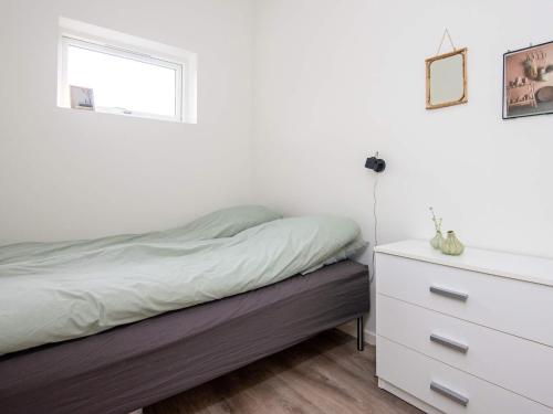 a bedroom with a bed and a dresser and a window at 8 person holiday home in Ansager in Ansager