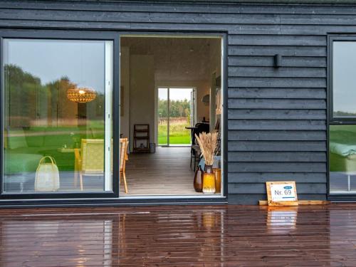 a house with sliding glass doors and a porch at 8 person holiday home in Ansager in Ansager