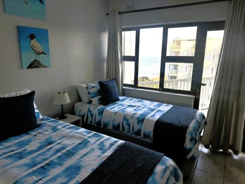 Ένα ή περισσότερα κρεβάτια σε δωμάτιο στο 4 Umdloti Cabanas Triplex