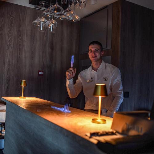 a man holding a knife in front of a counter at Santa Boka in Perast