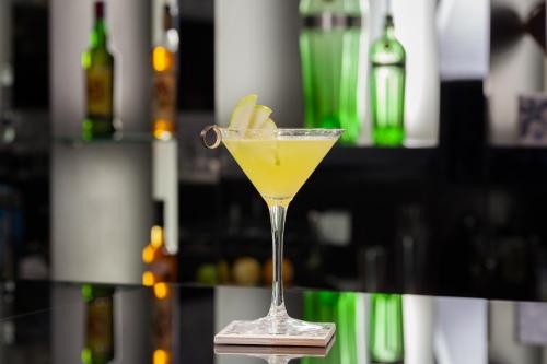 a drink in a martini glass with a banana in it at Hotel Cristal Porto in Porto