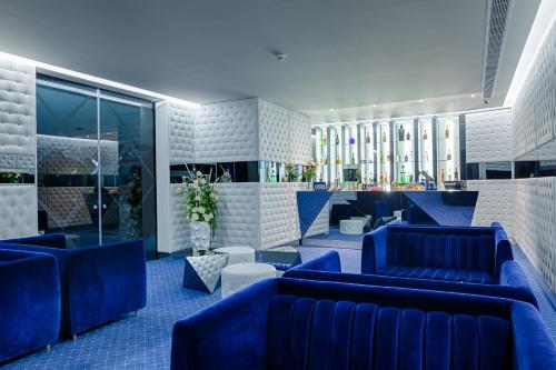 ポルトにあるホテル クリスタル ポルトの青いソファ、テーブル、窓が備わるロビー